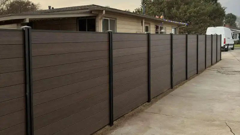 Modern composite fence panels with aluminum posts for residential privacy fencing