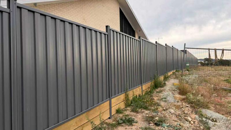 Colorbond-style steel fencing installed on a residential boundary