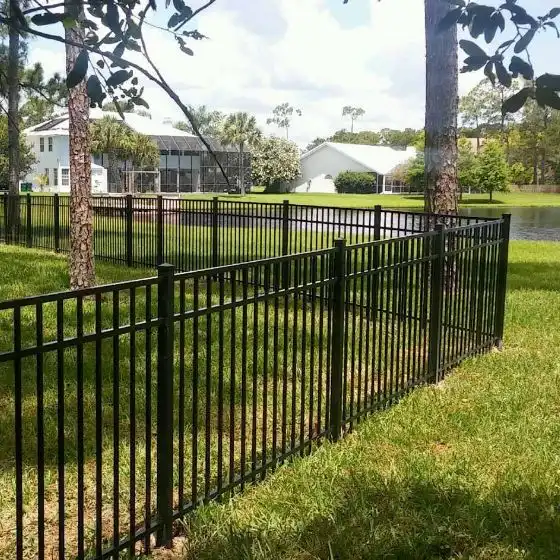 Tubular steel fencing panels protecting a commercial building perimeter