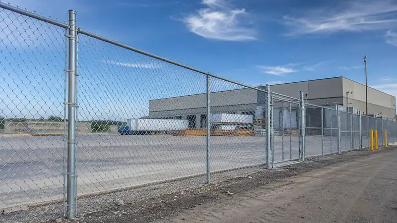 Galvanized chain link low maintenance fence for a warehouse and commercial storage yard