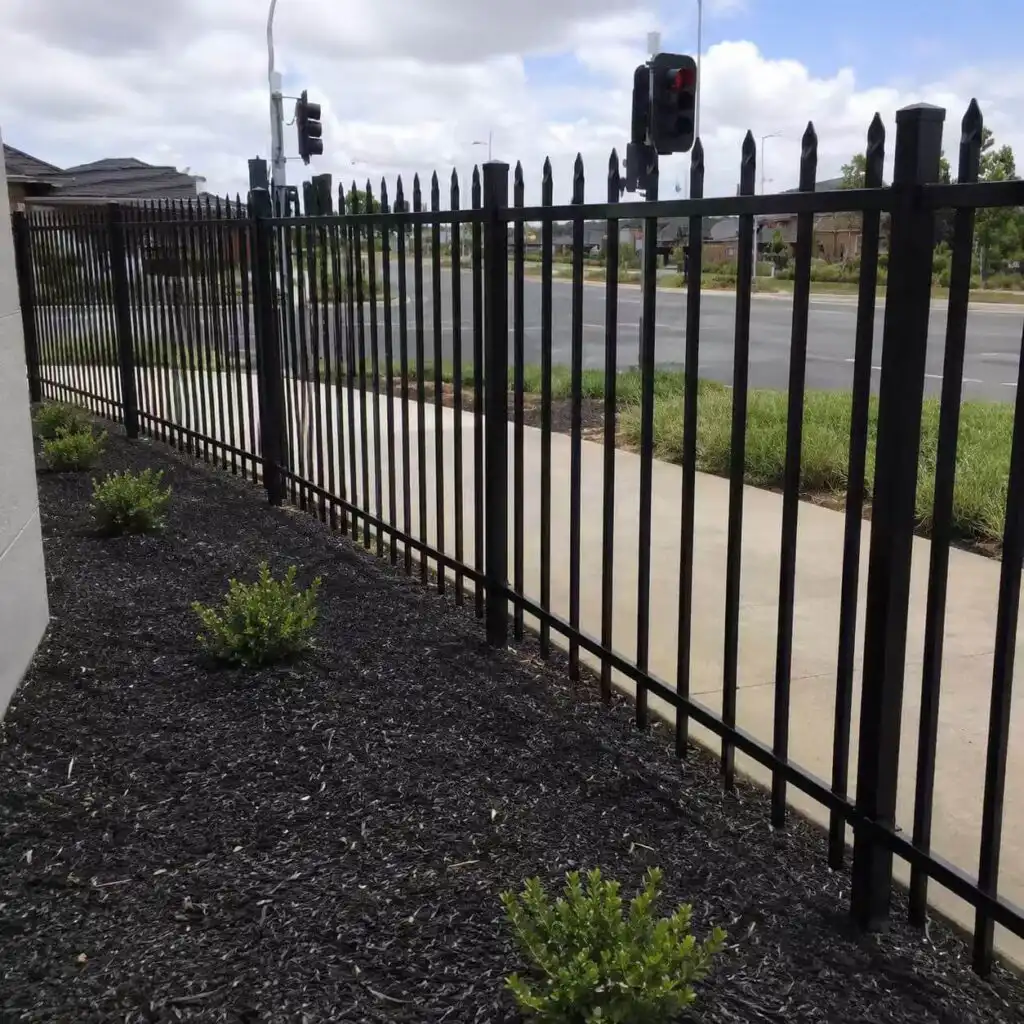 Tubular steel fence panels used for residential boundary fencing in a suburban housing project
