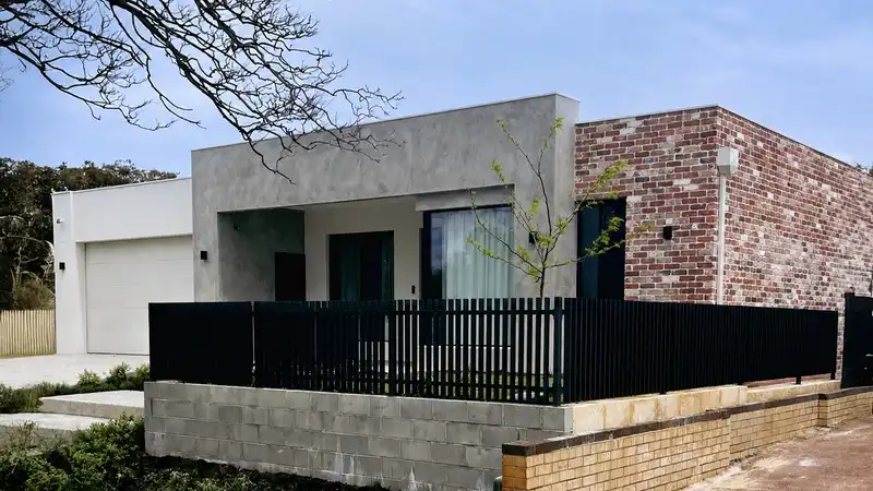 Black aluminium blade fence installed outside a modern Western Australia home